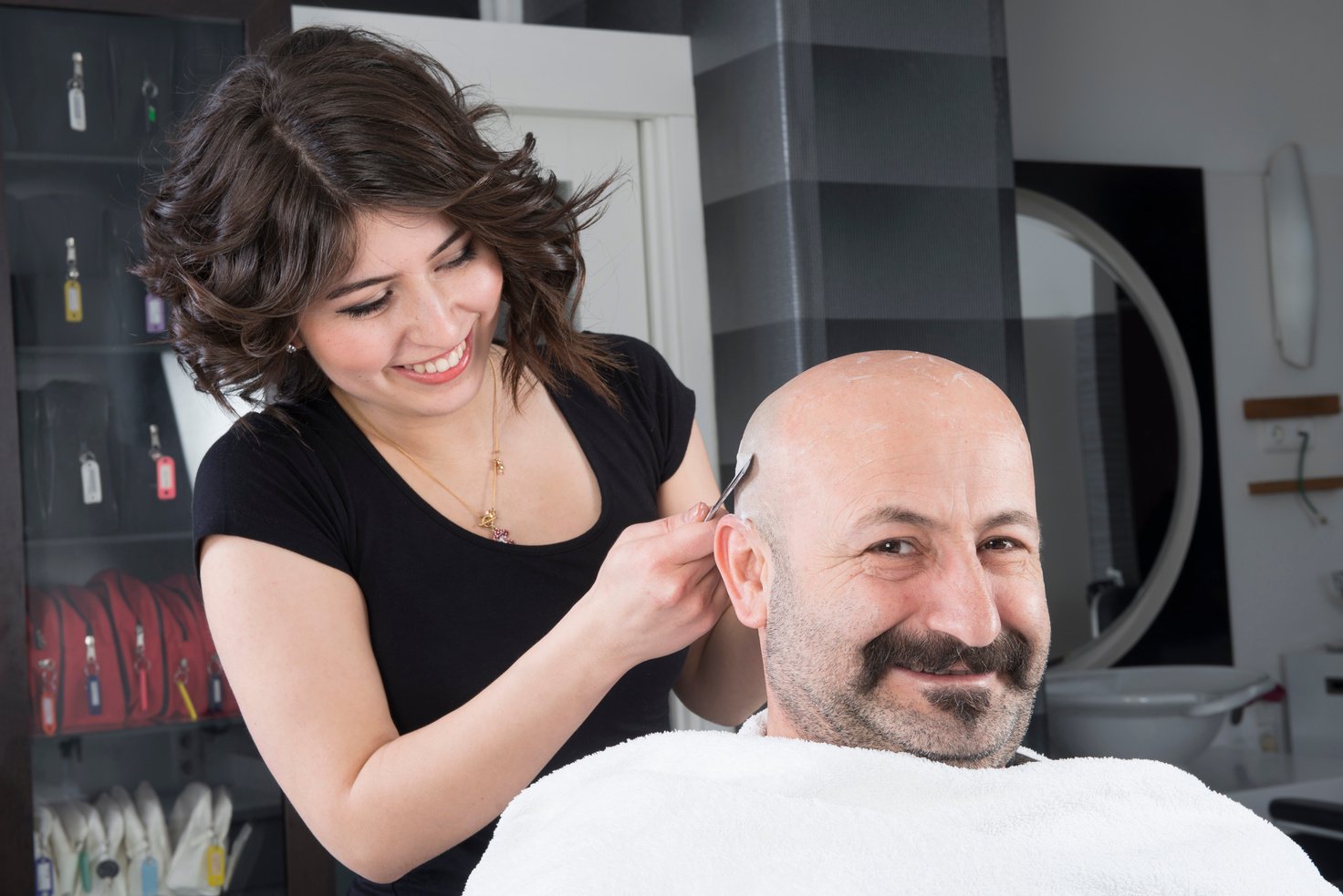 Beautiful young barber and customer