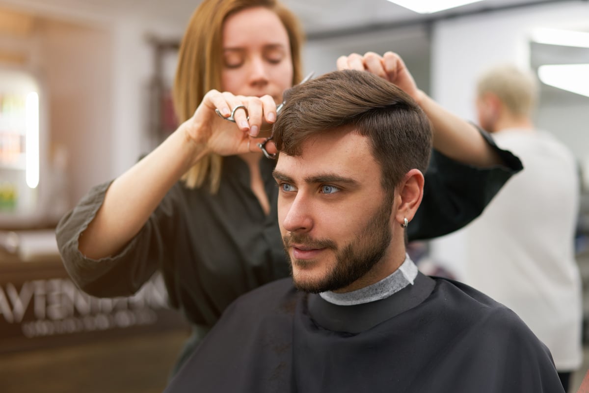 Man Getting Haircut with Female Hairdresser