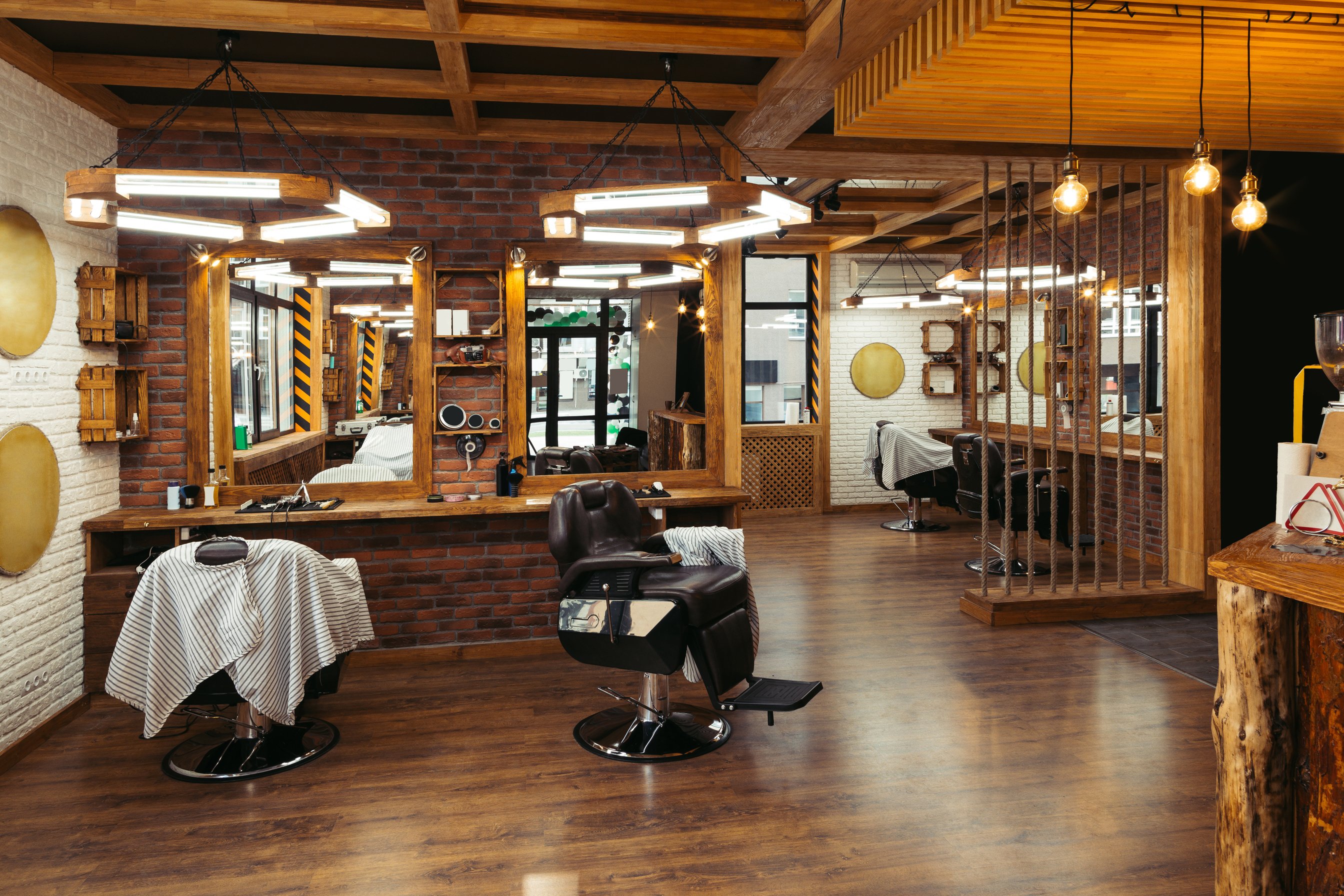 modern stylish empty barber shop interior with mirrors